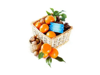 Festive basket of tangerines and walnuts with a “Merry Christmas” sign, highlighting seasonal sources of vitamin C.