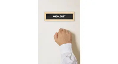 Person knocking on oncologist’s office door, symbolizing cancer diagnosis or treatment consultation