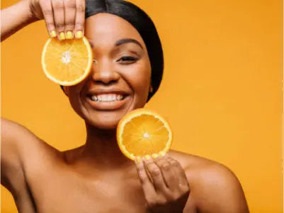 Smiling person holding fresh orange slices against a vibrant orange background, symbolizing the energizing and skin-boosting benefits of vitamin C. Would you like a few variations optimized for different tones—like playful, scientific, or beauty-focused
